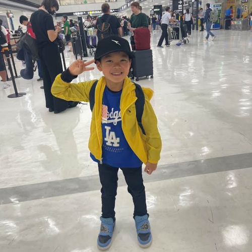 Young Learner at international airport joining AICOL Junior school summer camp
